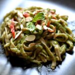 tagliatelle al grano saraceno con pesto di zucchine pomodorini e mandorle in scaglie